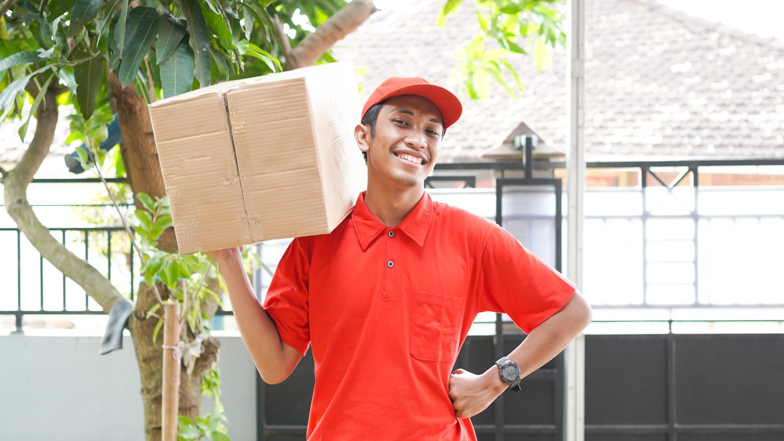 delivery-man-delivers-the-box-in-front-of-the-customer-s-house.jpg