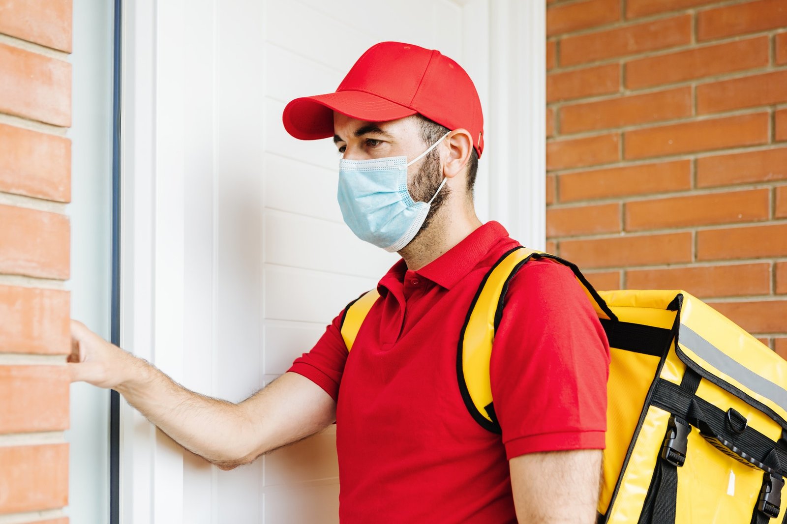 young-hispanic-delivery-food-man-in-face-mask-ringing-the-doorbell-food-delivery-concept.jpg